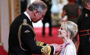Kylie recieving OBE from Price Charles
